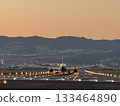 An airplane to land at the airport at dusk 133464890