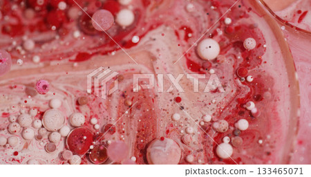 Oil fluid. Paint art. Defocused red white pink color flow wet bubble glitter liquid spreading on abstract bokeh acrylic background. 133465071