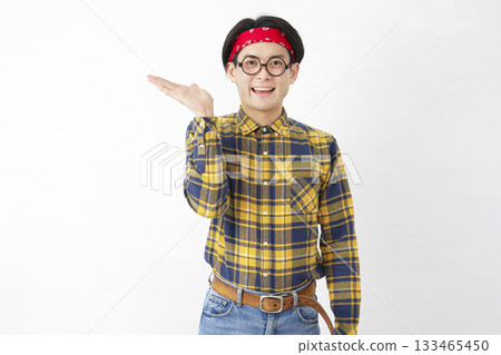 Akihabara-style man pointing to the left with palm on white background Akihabara-style man pointing to the left with palm on white background 133465450