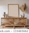 Wooden sideboard and blank picture frame Wooden furniture and poster mockup Wooden sideboard and blank picture frame Wooden furniture and poster mockup 133465662