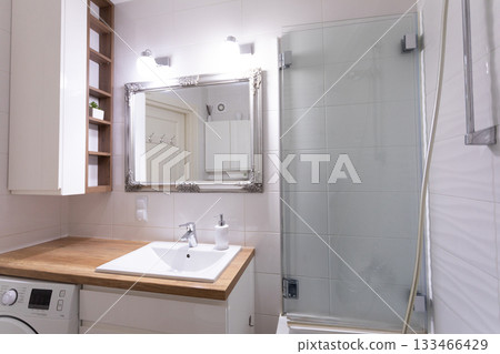 This is a beautifully designed modern bathroom interior featuring a sleek shower and stylish vanity This is a beautifully designed modern bathroom interior featuring a sleek shower and stylish vanity 133466429