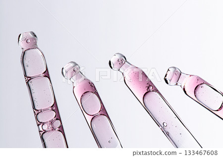 Skin serum in a pipette. A cosmetic product for body care. White background. Copy space 133467608