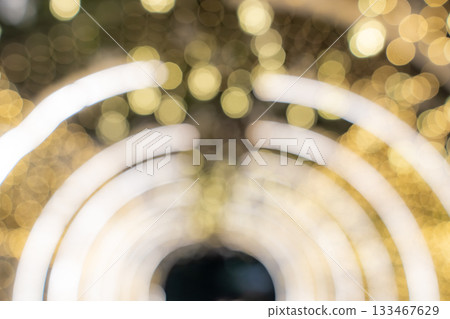 Warm golden bokeh fills the frame with soft circles of unfocused light, while curved LED lines create a bright tunnel effect in the background. Warm golden bokeh fills the frame with soft circles of unfocused light, while curved LED lines create a bright tunnel effect in the background. 133467629
