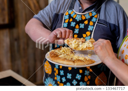 Homestyle dish with warm popcorn, Rustic kitchen scene with hands sharing popcorn on ceramic, Communal family moment with cook serving popcorn in cozy rustic environment Homestyle dish with warm popcorn, Rustic kitchen scene with hands sharing popcorn on ceramic, Communal family moment with cook serving popcorn in cozy rustic environment 133467717