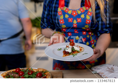 Enjoy a Delicious Homemade Pizza Served on a Beautiful Plate for Everyone to Enjoy 133467813