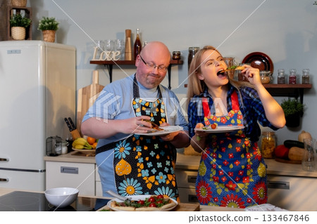 Couple preparing and enjoying Italian dishes, Two friends savoring and creating culinary delights at home, Joyful duo collaborating in kitchen with fresh ingredients Couple preparing and enjoying Italian dishes, Two friends savoring and creating culinary delights at home, Joyful duo collaborating in kitchen with fresh ingredients 133467846