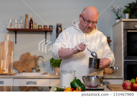 Cooking in the Kitchen A Skilled Chef Preparing and Presenting Fresh Ingredients Enthusiastically Cooking in the Kitchen A Skilled Chef Preparing and Presenting Fresh Ingredients Enthusiastically 133467960