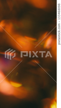 Defocused crystal flash. Flare blend. Bokeh night light mix color. Yellow orange brown prism shimmering texture abstract black background. Defocused crystal flash. Flare blend. Bokeh night light mix color. Yellow orange brown prism shimmering texture abstract black background. 133468098