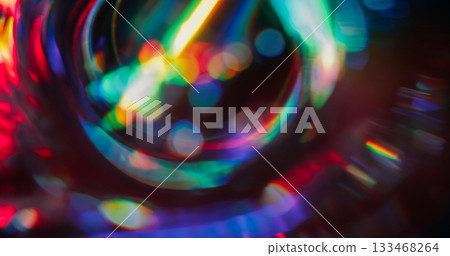 Defocused diamond crystal. Holographic flare. Neon colorful luminosity on dark black background. Spectrum sphere spin abstract bokeh effect. 133468264