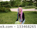 A Child Filled with Joy as They Enjoy Playtime Outdoors with a Bright Colorful Balloon 133468265