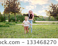 Joyful and carefree children are happily playing in the beautiful, vibrant nature outside 133468270