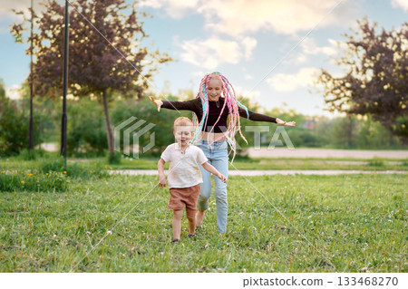 Joyful and carefree children are happily playing in the beautiful, vibrant nature outside 133468270