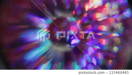 Spectrum light bokeh. Circular glow. Rainbow color shimmering sphere twinkle rays. Neon lens abstract purple red green blur background. 133468465