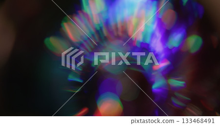 Round bokeh prism. Leak illumination. Neon color sphere shimmering kaleidoscope on black. Purple red green abstract blur background. Round bokeh prism. Leak illumination. Neon color sphere shimmering kaleidoscope on black. Purple red green abstract blur background. 133468491