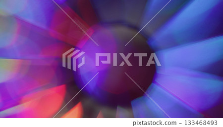 Blur glare. Round glow. Fluorescent abstract colorful kaleidoscope rays on dark background. Holographic neon purple red crystal sphere. Blur glare. Round glow. Fluorescent abstract colorful kaleidoscope rays on dark background. Holographic neon purple red crystal sphere. 133468493