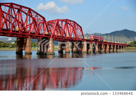 Auspicious train (Nana, Nankai Electric Railway) running over the Kinokawa Bridge [Wakayama City, Wakayama Prefecture] 133468648