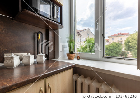 Cozy Kitchen Corner with Window View and Rustic Details 133469236