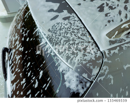 Foamy bubbles and shining surfaces during a weekend car wash on a sunny afternoon, capturing the joy of a clean ride Foamy bubbles and shining surfaces during a weekend car wash on a sunny afternoon, capturing the joy of a clean ride 133469339
