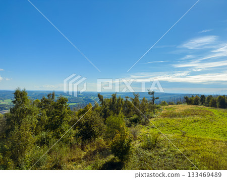 Breathtaking view of rolling hills and clear blue skies on a sunny day in the countryside during early afternoon Breathtaking view of rolling hills and clear blue skies on a sunny day in the countryside during early afternoon 133469489