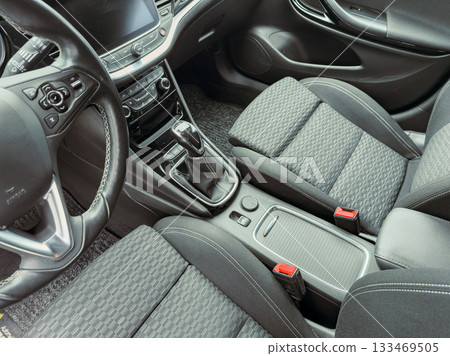 Modern car interior showcases sleek design and advanced features with comfortable seating and stylish dashboard, inviting a sense of luxury and adventure 133469505