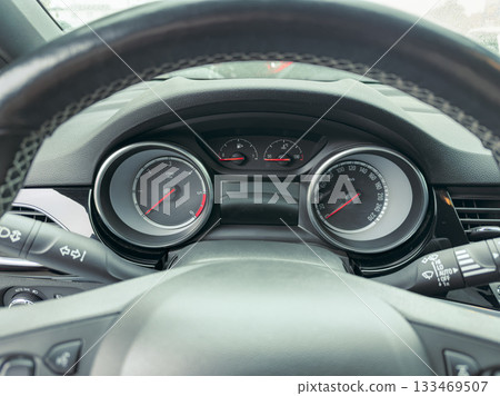 Exploring the dashboard of a modern vehicle during a rainy day drive 133469507