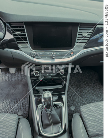 Modern car interior showcasing sleek design and advanced technology features at a sunny suburban driveway in the late afternoon 133469509