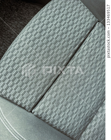 Stylish patterned fabric on a modern car seat interior showcasing unique textures and design Stylish patterned fabric on a modern car seat interior showcasing unique textures and design 133469517