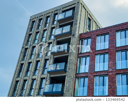 Modern architecture shines in urban setting with striking building designs and vibrant colors at sunset in a bustling city 133469542