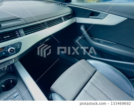 Sleek interior of a modern car showcasing elegant design and comfortable seating during a sunny day 133469692