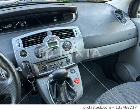 Dashboard view of a compact car showcasing modern controls and sleek design during a sunny afternoon drive 133469737