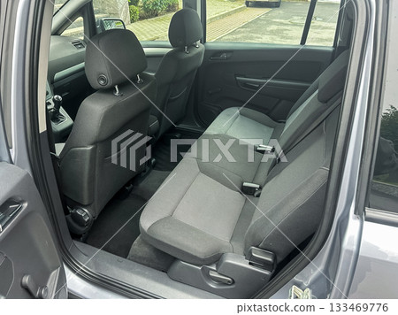 Exploring the interior of a modern vehicle with spacious seating and sleek design elements at a parked location on a clear day Exploring the interior of a modern vehicle with spacious seating and sleek design elements at a parked location on a clear day 133469776