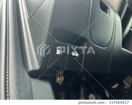 Detailed view of controls for fuel and trunk release in a modern car interior showcasing functionality and user-friendly design 133469817
