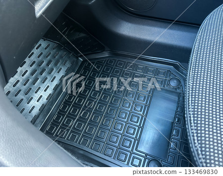 Clean and sturdy floor mat enhancing the interior of a vehicle with a focus on texture and protection from dirt and spills Clean and sturdy floor mat enhancing the interior of a vehicle with a focus on texture and protection from dirt and spills 133469830