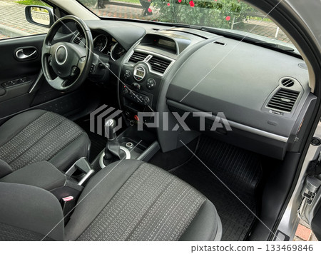 Interior view of a modern car showing sleek design and practical features in a cozy urban setting during daylight Interior view of a modern car showing sleek design and practical features in a cozy urban setting during daylight 133469846