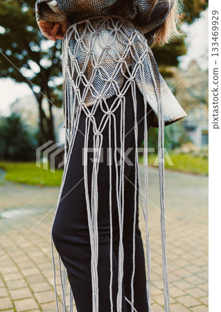 Creative fashion design showcasing unique macrame details in a vibrant outdoor setting during the afternoon 133469929