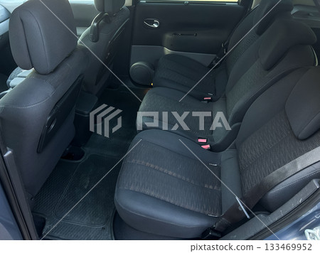 Comfortable interior view of a compact car showcasing a spacious seating arrangement for four passengers on a sunny afternoon 133469952