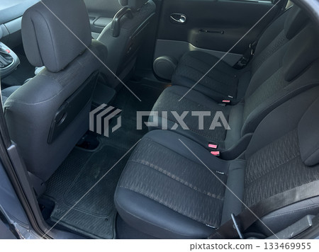 Comfortable backseat area in a sedan is ready for a journey through city streets during a sunny day in spring Comfortable backseat area in a sedan is ready for a journey through city streets during a sunny day in spring 133469955