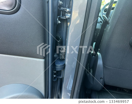 Detailed inspection of vehicle door mechanics reveals components and features in a modern automotive design Detailed inspection of vehicle door mechanics reveals components and features in a modern automotive design 133469957