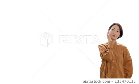 Woman listening to music or the radio with earphones (center) 133470133