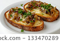 Toasted loaf bread melted cheese caramelized simple lunch on white plate 133470289