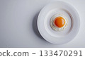 Egg yolk on white plate for simple breakfast in table 133470291