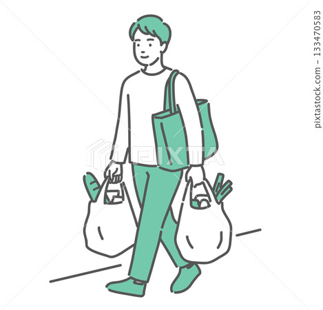 一位年輕男子雙手提著購物袋行走 一位年輕男子雙手提著購物袋行走 133470583