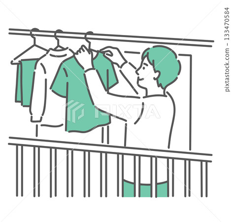 A young man hanging out laundry on the balcony A young man hanging out laundry on the balcony 133470584