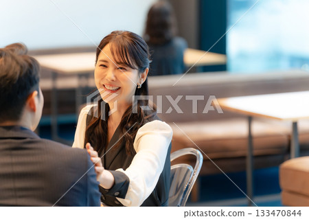 Smiling couple having a conversation in the lobby 133470844