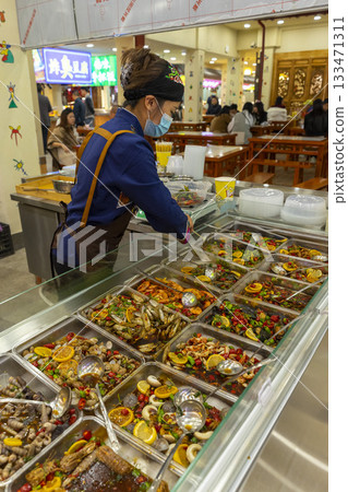 Lijiang, China - April 9, 2024 : Street food skewers in the old town of Lijiang, China on April 9, 2024. Lijiang, China - April 9, 2024 : Street food skewers in the old town of Lijiang, China on April 9, 2024. 133471311