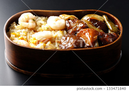 蝦仁炒飯和黑醋糖醋豬肉便當，以黑色背景拍攝。 133471840