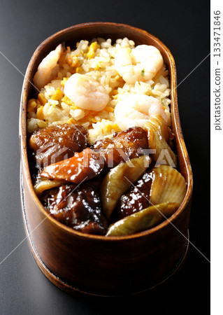 Shrimp fried rice and black vinegar sweet and sour pork bento photographed against a black background Shrimp fried rice and black vinegar sweet and sour pork bento photographed against a black background 133471846
