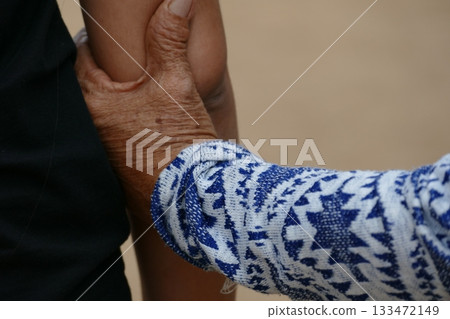 Asian senior or elderly old lady woman patient hold hand on her chest with love and care, healthy strong medical concept. 133472149