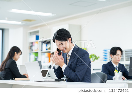 A young businessman calling in the office 133472461