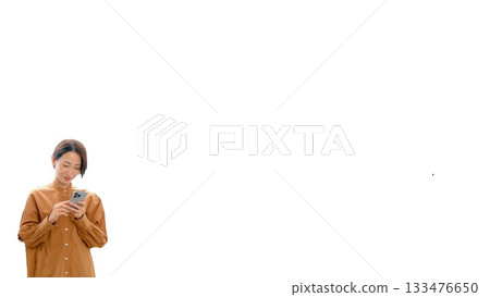 A woman operating a mobile phone (small) A woman operating a mobile phone (small) 133476650